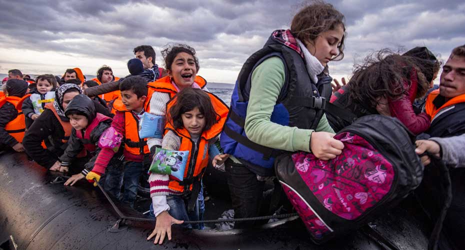 Migrants on a boat on sea